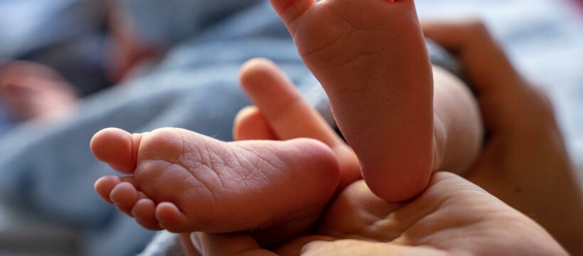 Faith with Feet-man's hand holding a baby's feet