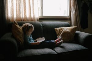 Never Will I Leave You--small girl reading in front of a window