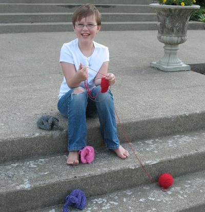 Little Elephants--Big Difference--Cee Cee knitting on church steps