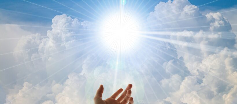 Ever-Present God-- Hand reaching to bright light among clouds