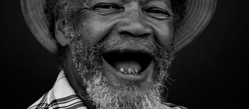 An old man with a huge toothless smile.